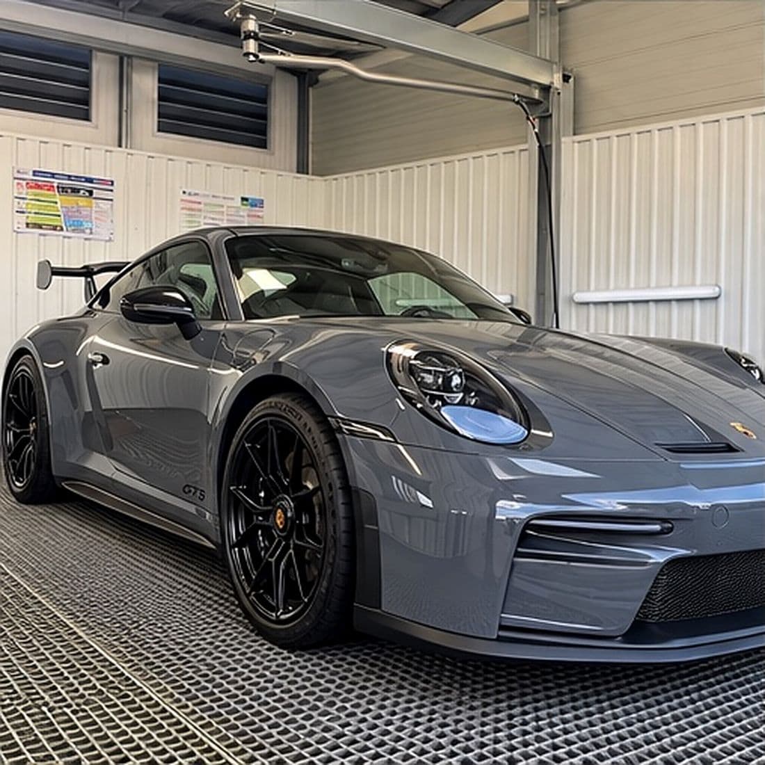 Grey Porsche 911 in the vehicle detailing studio